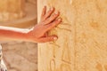 Image of hand touching Egyptian hieroglyphs in Mortuary Temple of Hatshepsut