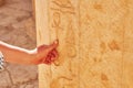 Image of hand touching Egyptian hieroglyphs in Mortuary Temple of Hatshepsut
