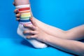Image of hands holding leg in socks with rainbow colors