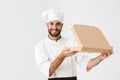 Image of handsome baker man in cook uniform smiling and holding pizza box Royalty Free Stock Photo