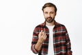 Image of handsome bearded man pointing finger at camera, squinting suspicious, figure something out, its you gesture