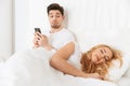 Handsome young man chatting while his wife sleeping. Royalty Free Stock Photo