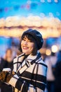 Image of happy brunette with glass in hands on walk on street Royalty Free Stock Photo