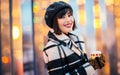 Image of happy brunette with glass in her hands on walk on street Royalty Free Stock Photo