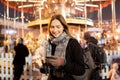 Image of happy brunette with glass and phone in hands in evening for walk Royalty Free Stock Photo