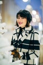 Image of happy brunette near white artificial Christmas tree on walk at street Royalty Free Stock Photo