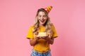 Cheery birthday woman holding cake with candle