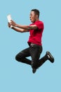 Image of happy excited young african man jumping isolated over yellow background using laptop Royalty Free Stock Photo