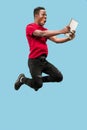 Image of happy excited young african man jumping isolated over yellow background using laptop Royalty Free Stock Photo