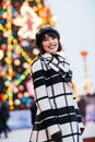 Image of happy girl on street , blurred background with burning garland Royalty Free Stock Photo