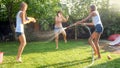 Photo of happy laughing family splashing water with water guns and garden hose at backyard. People playing and having Royalty Free Stock Photo