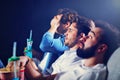 Group of happy friends sitting in cinema watch film and eating popcorn Royalty Free Stock Photo