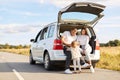 Image of happy mother and father traveling together with their infant daughter by comfortable car, having rest drinking tea or Royalty Free Stock Photo