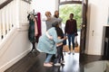 Image of happy multi generation african american family entering house and welcoming each other