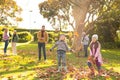 Image of happy multi generation caucasian family having fun with leaves in autumn garden Royalty Free Stock Photo