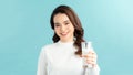 Image of happy positive optimistic young beautiful woman posing isolated over blue wall background holding milk