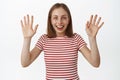 Image of happy smiling blond woman waving hands, say goodbye or hello, greeting or farewell, looking friendly and joyful Royalty Free Stock Photo