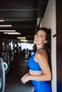 Image of happy sports girl standing over wall. Looking at camera. Female resting after fitness. Royalty Free Stock Photo