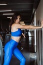 Image of happy sports girl standing over wall. Looking at camera. Female resting after fitness. Royalty Free Stock Photo