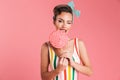 Happy young pin up woman holding candy lollipop. Royalty Free Stock Photo