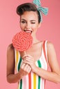 Happy young pin up woman holding candy lollipop. Royalty Free Stock Photo