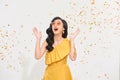 Image of happy young woman posing isolated over white background wall over confetti Royalty Free Stock Photo