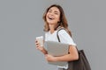 Image of happy young woman 20s laughing and standing over gray w Royalty Free Stock Photo