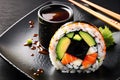 One Delectable Sushi Roll Centered on a Matte Black Plate - Top View, Soy Sauce Drizzled Artistically