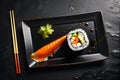 One Delectable Sushi Roll Centered on a Matte Black Plate - Top View, Soy Sauce Drizzled Artistically