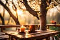 A beautiful morning sunrise scene with the sun rising between jungle trees. A close-up of a coffee cup on a table beside the lush Royalty Free Stock Photo