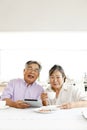 Japanese senior couple, enjoying coffee in the kitchen at home, Royalty Free Stock Photo