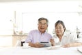 Japanese senior couple, enjoying coffee in the kitchen at home, Royalty Free Stock Photo