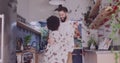 Image of hearts over diverse couple dancing in kitchen Royalty Free Stock Photo