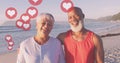 Image of hearts over happy senior african american couple on sunny beach Royalty Free Stock Photo