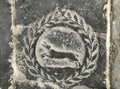 Image of a heir with a laurel wreath on a tomb