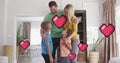 Image of herts over happy caucasian family embracing at home Royalty Free Stock Photo