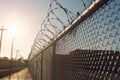 An image of a high-security prison fence or perimeter wall, symbolizing the separation between inmates and the outside world.