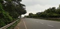 Indian street, sky, trees, Cloudy Sky, city road, highway, road marking, bicycle line, car, Cuttack, India Royalty Free Stock Photo