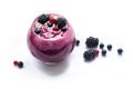 Image of homemade antioxidant berry smoothie decorated with seeds and berries. Delicious dessert on white background