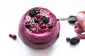 Image of homemade antioxidant berry smoothie decorated with seeds and berries. Delicious dessert on white background