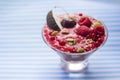 Image of homemade antioxidant berry smoothie with seeds, coconut, cherries and rasberry. Delicious dessert on violet