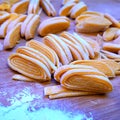 Image of homemade noodles on a wooden chopper