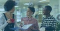 Image of hud processing over multiracial female colleagues discussing files during coffee break Royalty Free Stock Photo