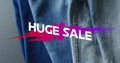 Image of huge sale text over denim trousers background