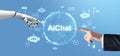 Image of a human hand and a robotic hand pointing at the Ai text. Blue background with various chat icons. Concept of AI-driven