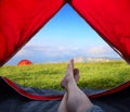 Image human legs lying in tourist tent