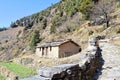 Hut in a Himalayan Village with Rocky Trek with Trees and Mountain in Background - Uttarakhand, India