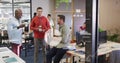 Image of icons, graphs, map and computer language over diverse coworkers talking on tea break