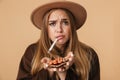 Image of ill girl holding bunch of pills with thermometer in her mouth