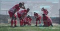 Image of interface and data with world map over diverse group of tired male footballers on pitch